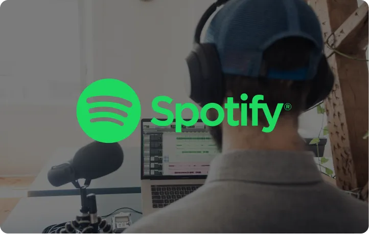 Person wearing headphones facing a laptop with audio editing software, with Spotify logo overlay.